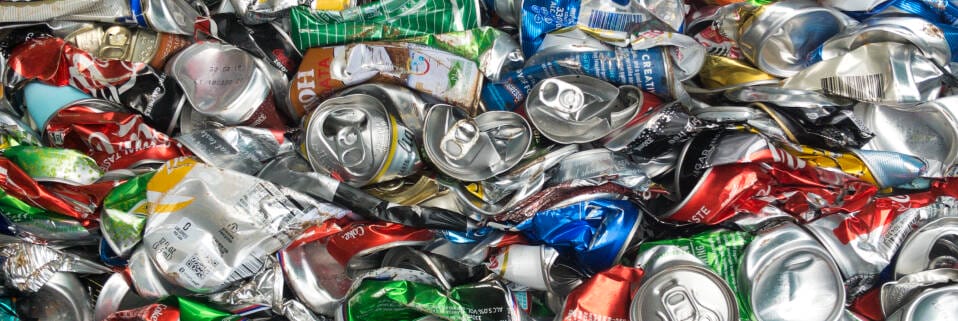 Crushed colorful aluminum cans for recycling.