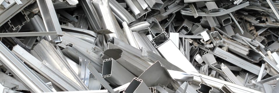 Scattered aluminum extrusions for recycling.