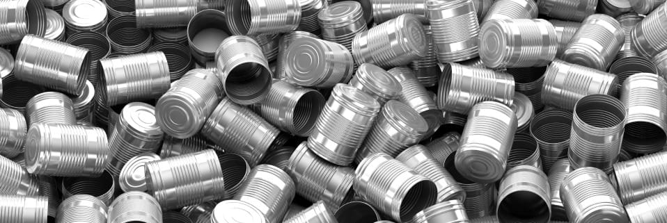 Heap of discarded aluminum cans in monochrome.